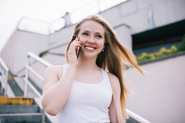 Positive female meloman enjoying audio podcast set