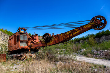 Excavator in a sand quarry. Stone extraction in the canyon.