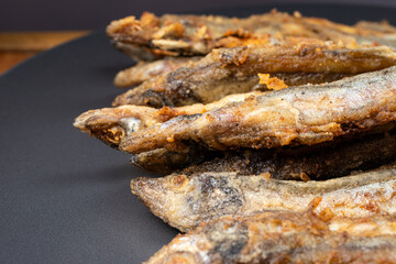 Fried capelin fish. Small fish, fried in vegetable oil in a frying pan.