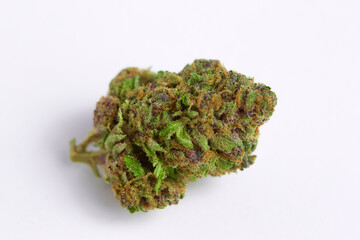 Close up of prescription medical marijuana and recreational weed hybrid OG strain sticky flower bud isolated on a white background