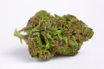 Close up of prescription medical marijuana and recreational weed hybrid OG strain sticky flower bud isolated on a white background