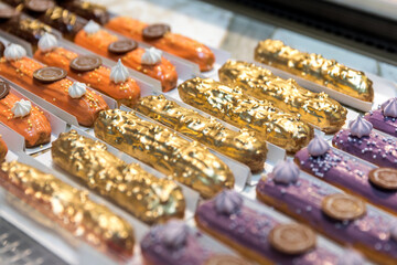 Beautiful decorated eclairs in a candy store window