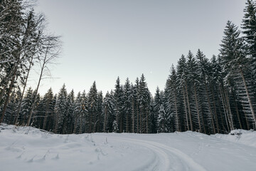 A man riding a snowboard down a snow covered slope