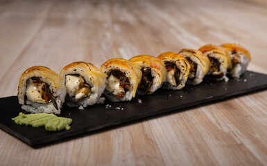 Japanese Sushi Board, Goat Cheese Urimaki and Apple on wooden background.