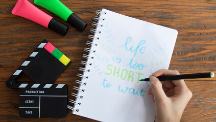 Flat lay stylish set. School stationery. Back to school concept. Top view of modern school supplies on table. Trendy back to school mock up with handmade motivational quotes over wood background.