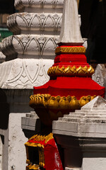 Natural and red and golden painted pagodas used as graves for clerk and monks of a wat or buddhist...