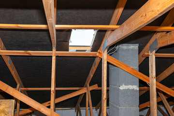 Attic with visible trusses, roof hatch for a chimney sweep and with a system chimney.