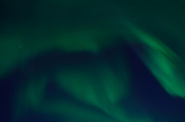 Fototapeta na wymiar beautiful aurora borealis dancing on autumn night sky