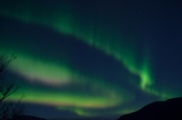 colorful aurora borealis dancing over mountain