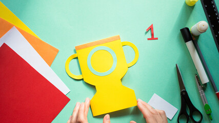 How to make greeting card for Father’s Day in shape of goblet,winner cup. Children gift for Daddy. Step 10. Simple creative art project. Step by step instructions.Easy paper applications. DIY concept