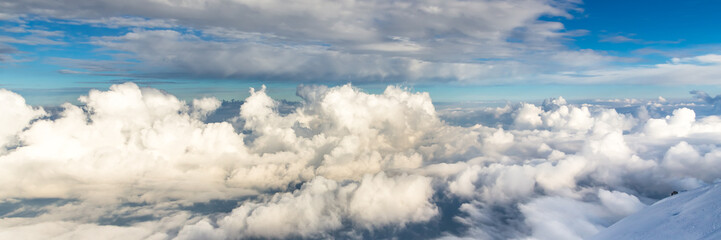 Blue sky background with tiny clouds in panoramic view. Mount Blanc.