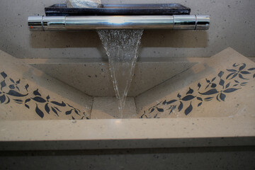 DECORATIVE , DESIGNER WASHBASIN WITH WATERFALL TAP AND FLOWER DESIGN IN IT