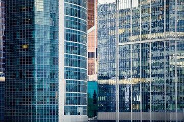 Office and residential skyscrapers in city downtown close up. Commercial real estate. Financial city district. Modern business city district. Office buildings exterior and facade design. In the city.