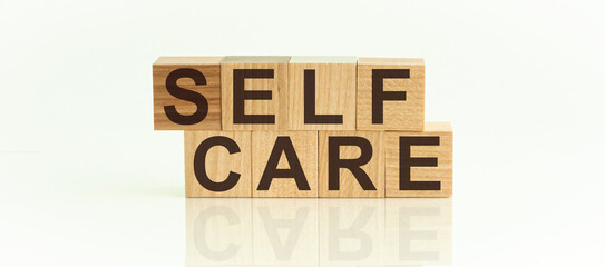 SELF CARE - text on wooden cubes on a white background