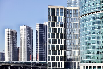 Office and residential skyscrapers on bright sun and clear blue sky background. Commercial real estate. Modern business city district. Office buildings exterior. Financial city district. Downtown.