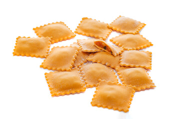 Fresh ravioli pasta colored with paprika isolated on a white background, close up