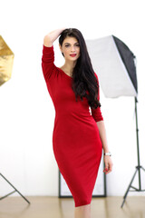 beautiful lady in red dress in studio