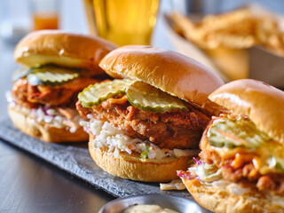 spicy nashville hot chicken sandwich with coleslaw and pickles - obrazy, fototapety, plakaty