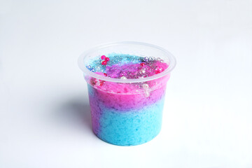 Boxes of colored slime with decorations over light background. Children fun and leisure activities. 
