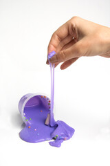 Boxes of colored slime with decorations over light background. Children fun and leisure activities. 