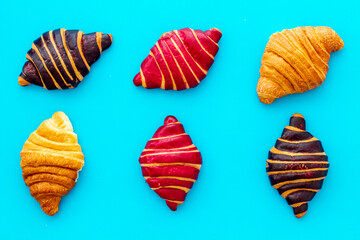 Croissants pattern - set of snacks on blue background