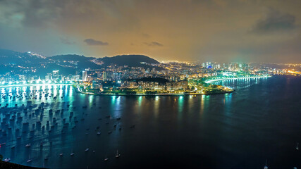 Naklejka premium Night view of Rio de Janeiro as the city lights glow, view from Sugarloaf Mountain.