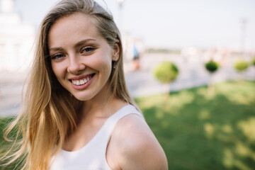 Happy Caucasian woman with blonde hair laughing on urban setting