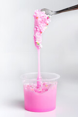 Boxes of colored slime with decorations over light background. Children fun and leisure activities. 