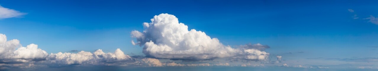 Panoramic View of Puffy White Clouds with Blue Sky during a beautiful Sunny Day. Taken over Vancouver, British Columbia, Canada.