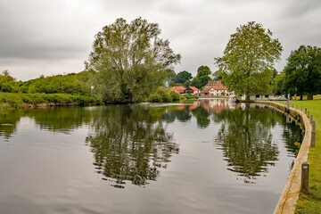 Fototapeta na wymiar View down the empty public moorings on the River Bure in the Norfolk village of Coltishall