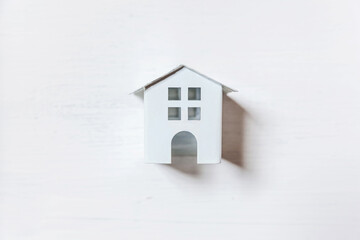 Fototapeta na wymiar Simply minimal design with miniature toy house isolated on white background. Mortgage property insurance dream home concept. Flat lay top view, copy space