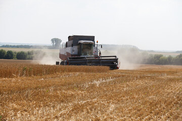Combine harvester working in a very wide wheat field
