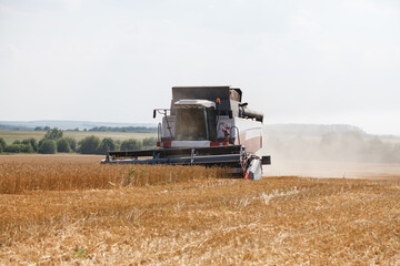 Combine harvester working in a very wide wheat field