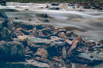 A river running by the rocks.