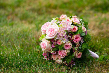bride’s wedding bouquet, beautiful bouquet, delicate flowers on green grass