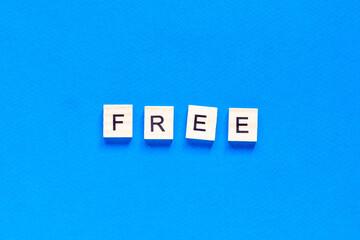 the inscription is made in wooden letters on a blue background. Business concept, sales, stores, gifts.