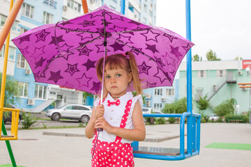 Little girl lovely baby with tails in the rain with umbrella