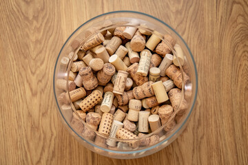 Collection of wine corks inside glass vase closeup. Wine bar backdrop