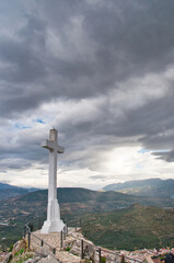 stone cross monument overlooking the mountains