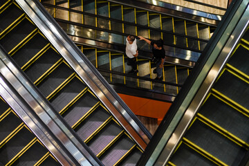Masked people on escalators