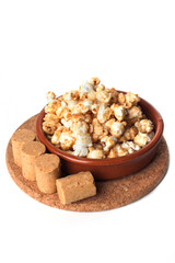 Rustic kitchen utensils with gourmet peanut candy popcorn isolated on white background.