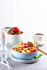 Pancake cereal, mini pancakes in a bowl with strawberries