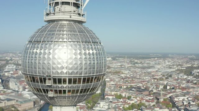 AERIAL: Super Close Up View Circle around the Alexanderplatz TV Tower in Berlin, Germany on hot summer day