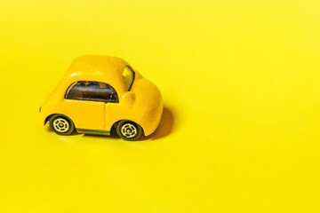 Simply design yellow vintage retro toy car isolated on yellow background. Automobile and transportation symbol. City traffic delivery concept Copy space