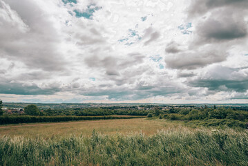 English countryside landscape beautiful sky clouds and green grass and trees