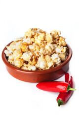 Detail of gourmet pepper and caramel popcorn over white background.