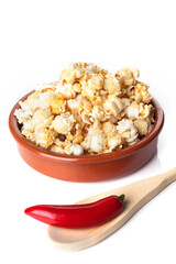 Detail of gourmet pepper and caramel popcorn over white background.