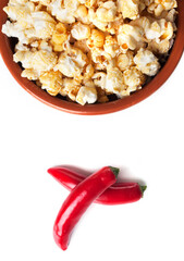 Detail of gourmet pepper and caramel popcorn over white background.