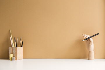 Workspace with brown wall and vintage office supplies. The home office of the artist.