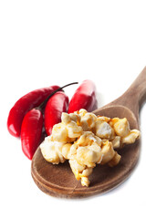 Detail of gourmet pepper, lemon, caramel popcorn over white background. Rustic utensils
